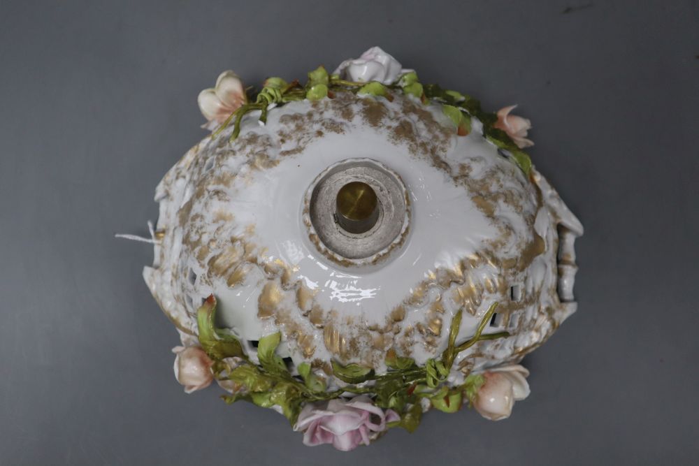 A Sitzendorf floral encrusted porcelain fruit stand, on a figural support, overall height 40cm